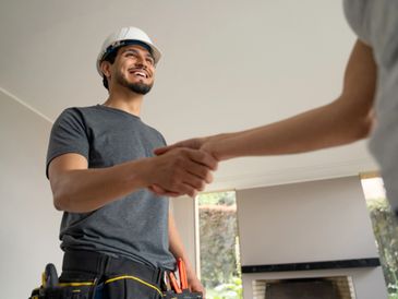 Construction professional handshake — property refurbishment